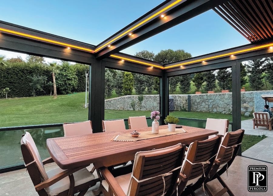 SkySlide retractable louvered residential pergola with yellow LED lights